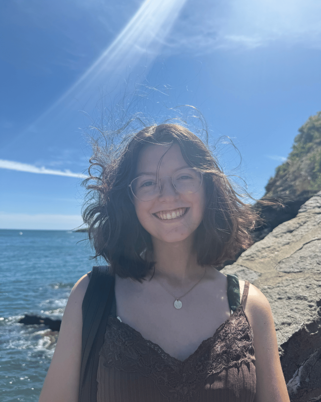 Ella smiling at a beach