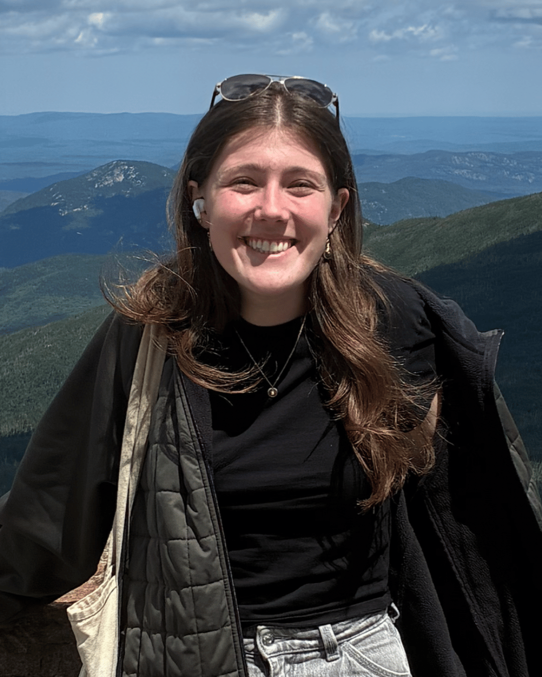 Sarah smiling in front of mountain range