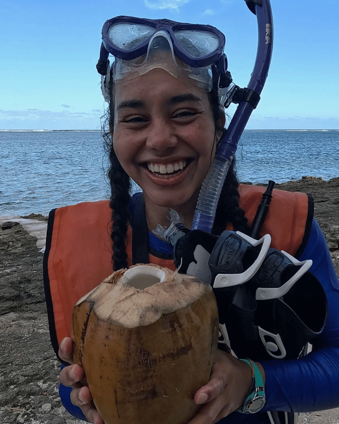 Anna in a snorkle holding an open coconut 