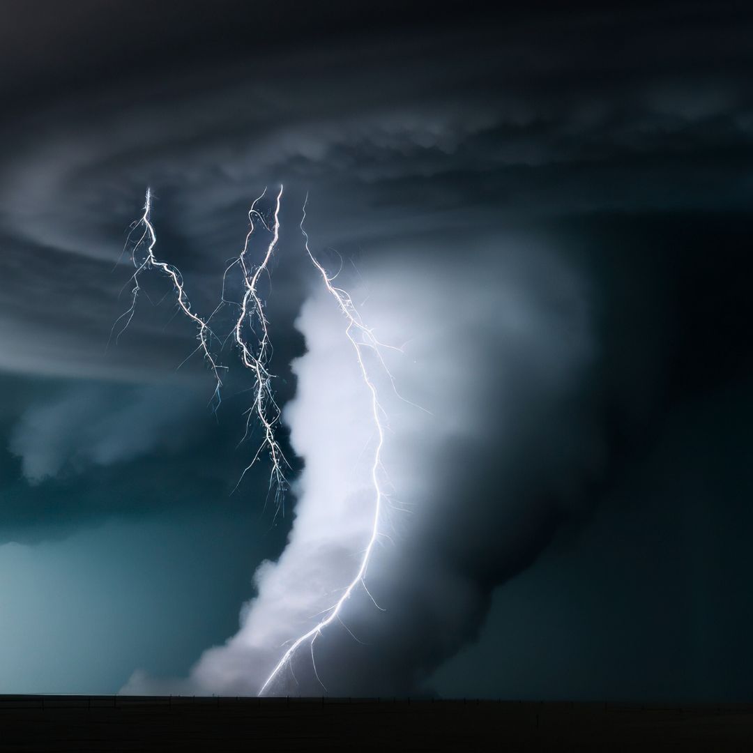 a dark cloud, with a tornado spout and lightning 