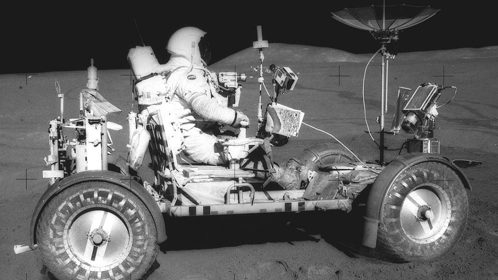 Dave Scott driving the Lunar Roving Vehicle in the Plains of Hadley on the moon.