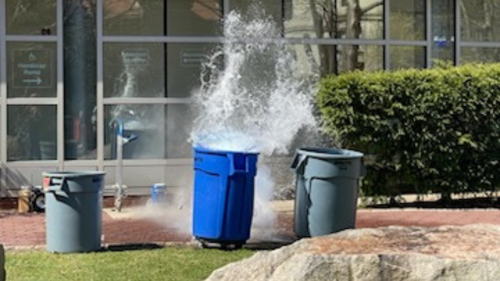 An explosion of water erupting from the trash bucket for the volcano demo. 