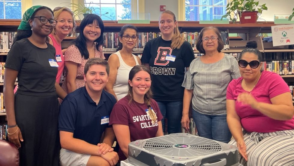 REU students and library program guests pose for a photo.