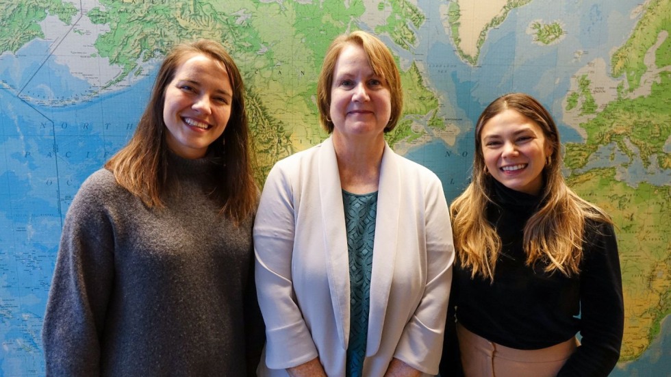 Mali'o Kodis, Karen Fischer, and Isabella Gama Dantas smiling for a photo together. 