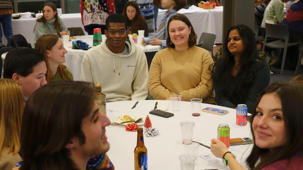 A few grad students smile for a photo. 