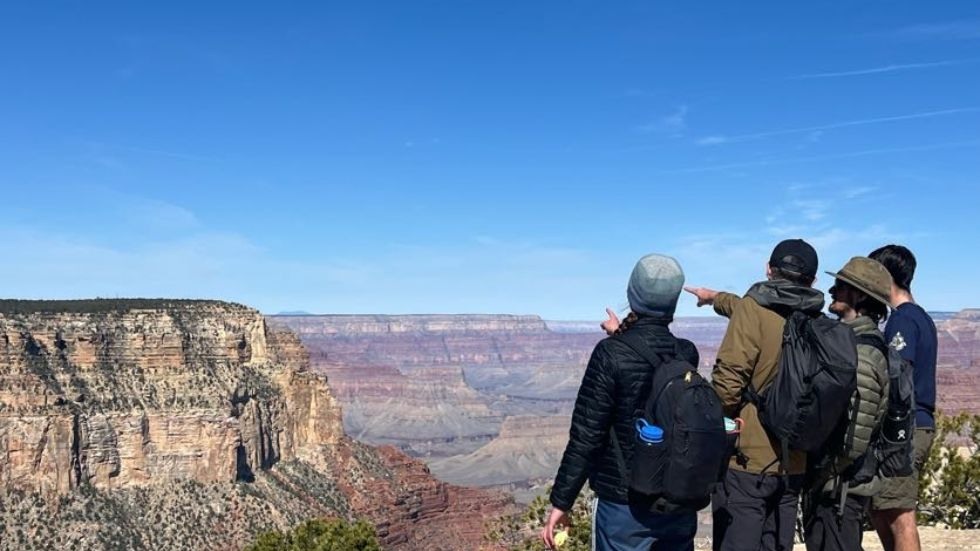 Students point out the canyon features above a grand vista 