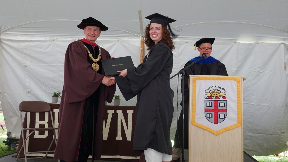 graduate receiving their diploma from Chancellor Samuel Mencoff