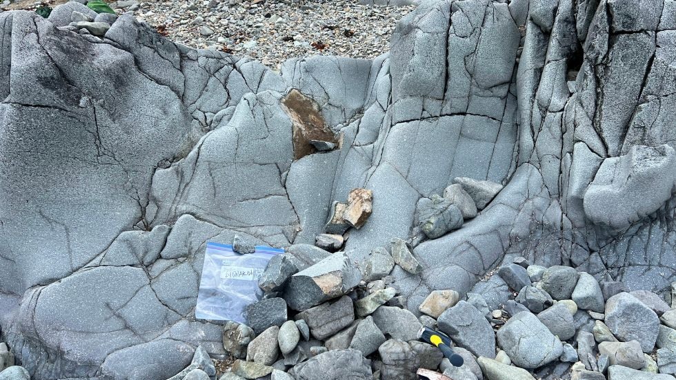 A stone formation and bag of rock samples 