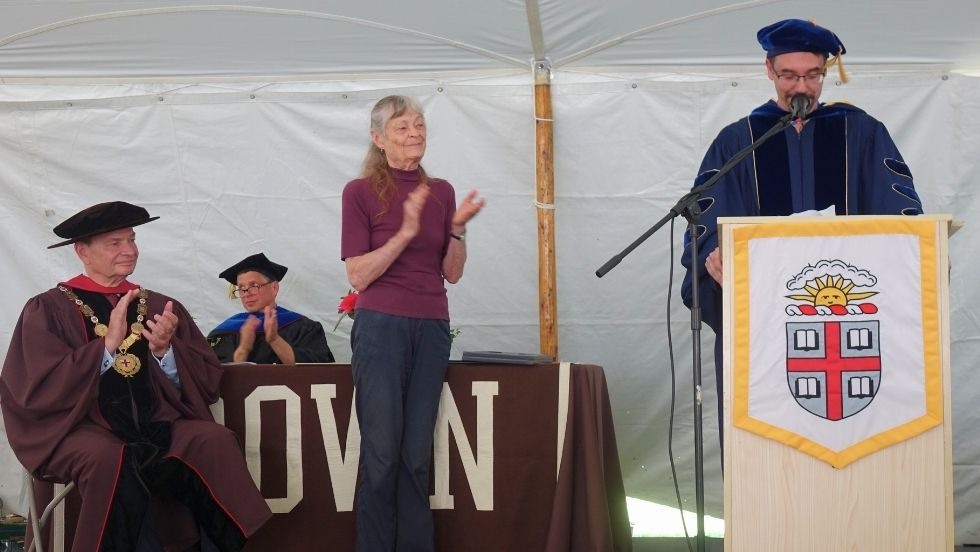 Jan applauding students at graduation May 2024