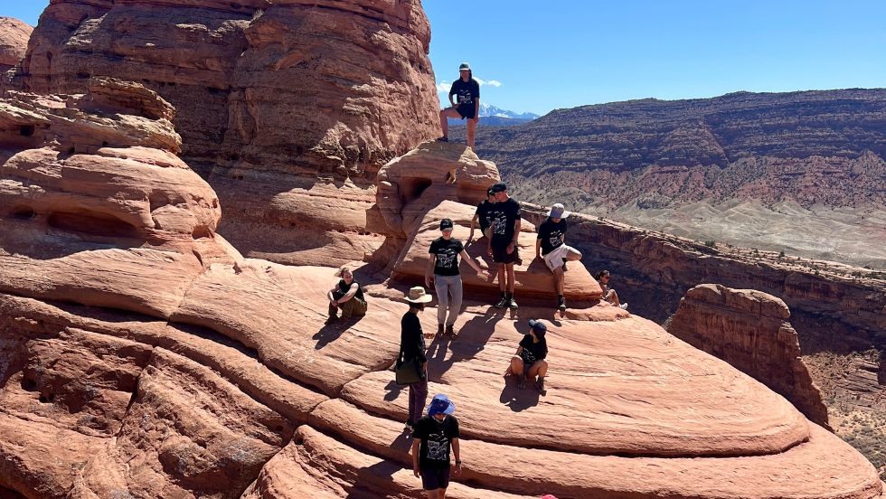 students hiking up a unique rock formation