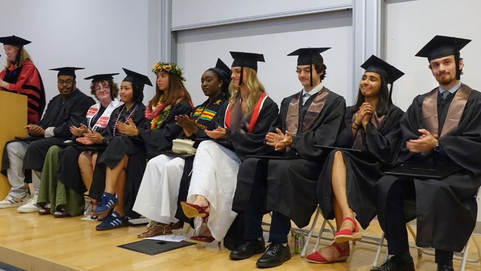 graduating students seated together on stage during the ceremony