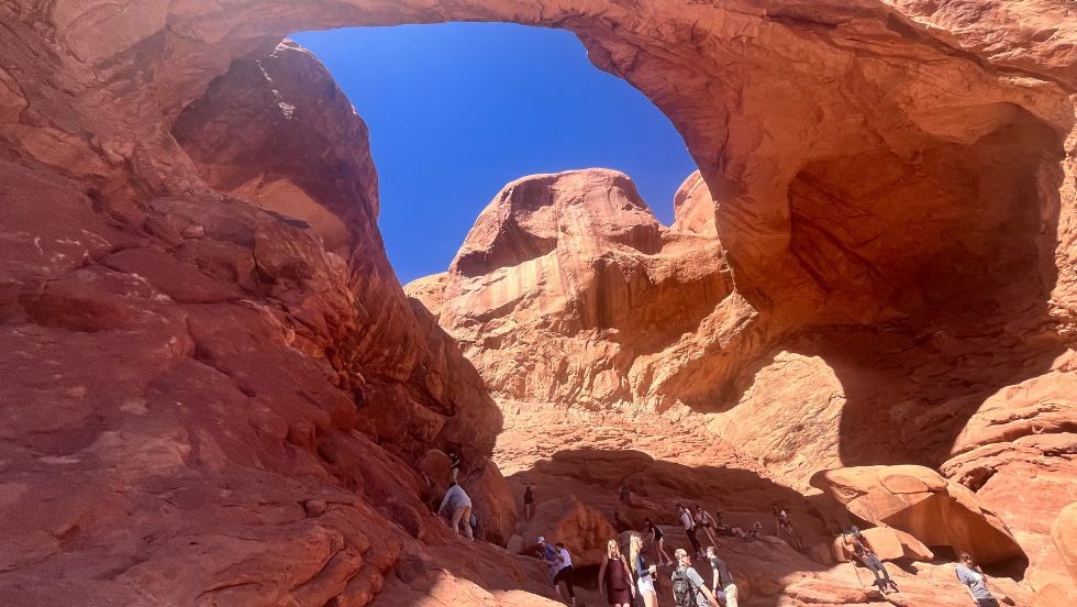students hiking up unique stone arches