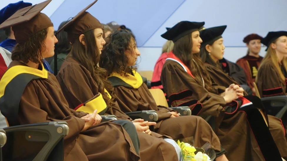 graduates seated together before the ceremony