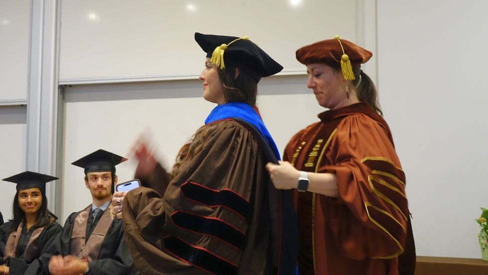 Prof Cooperdock bestowing graduate hood on Anahi Carrera