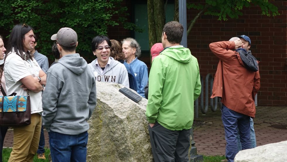 folks mingling beside the stones during the Jan memorial picnic 