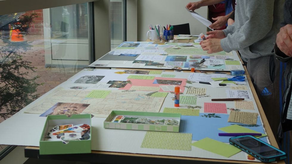 folks adding notes to the Jan memorial tapestry project 