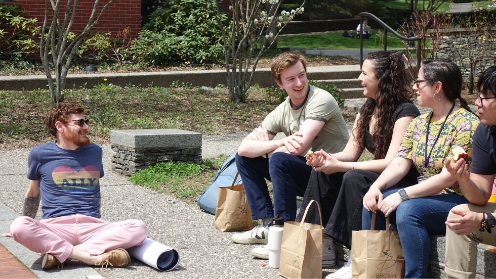 participants enjoying casual conversation during lunch outside