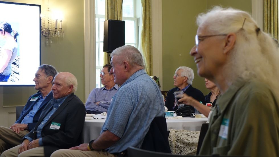 Ellen Shelton, Bill Collins, Terry Tullis, and others sit and listen during the reception 