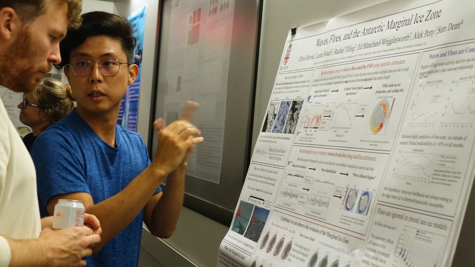 two DEEPS community members discussing a poster 