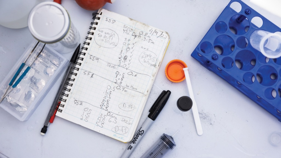 a top-down photo of a scientist's notebook, samples, measurements and tools on a table at the Salton Sea project 