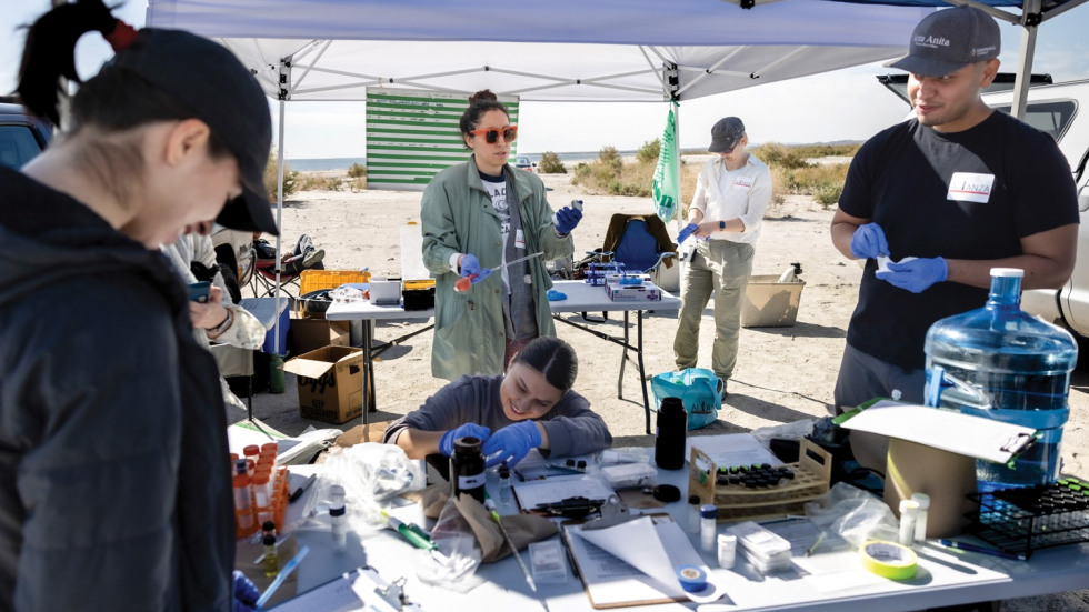Alejandra Lopez discussing samples with fellow scientists on site at the Salton Sea