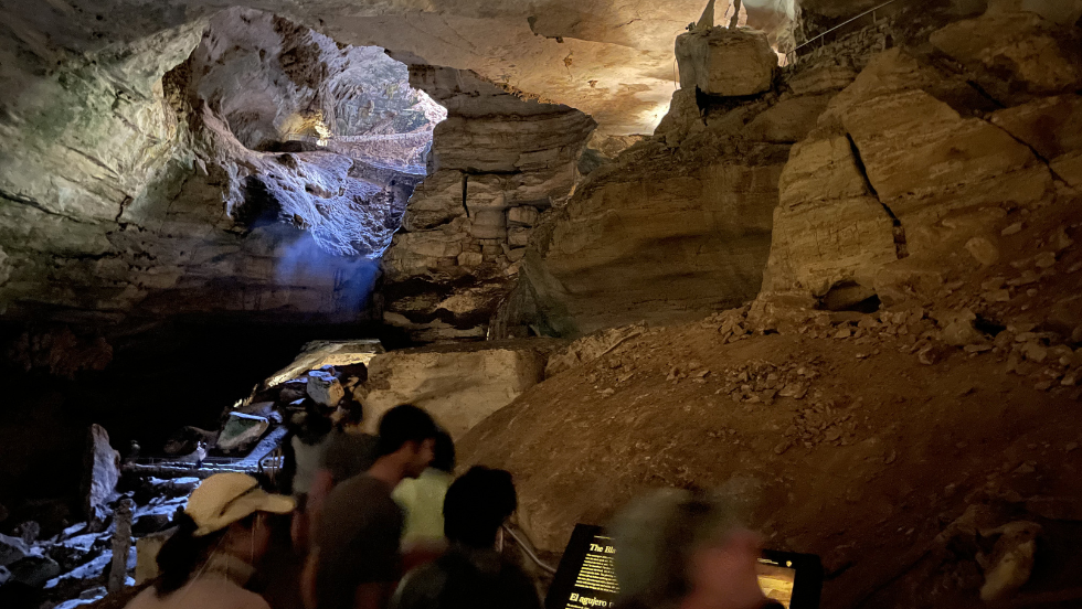 students (blurry) exploring large caves