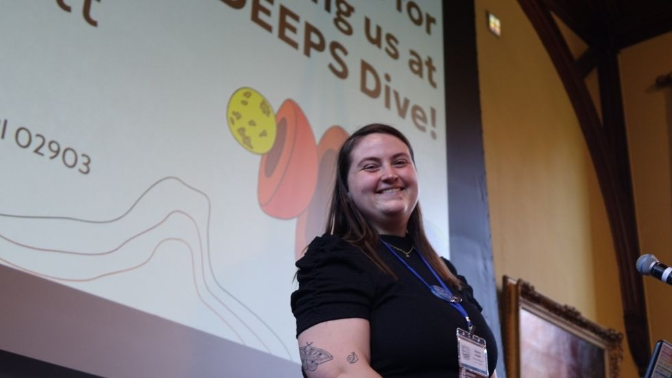 organizer Brianna smiling from the stage