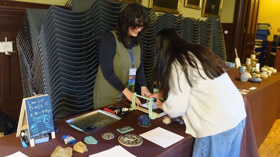 students block-printing at the community art activity 