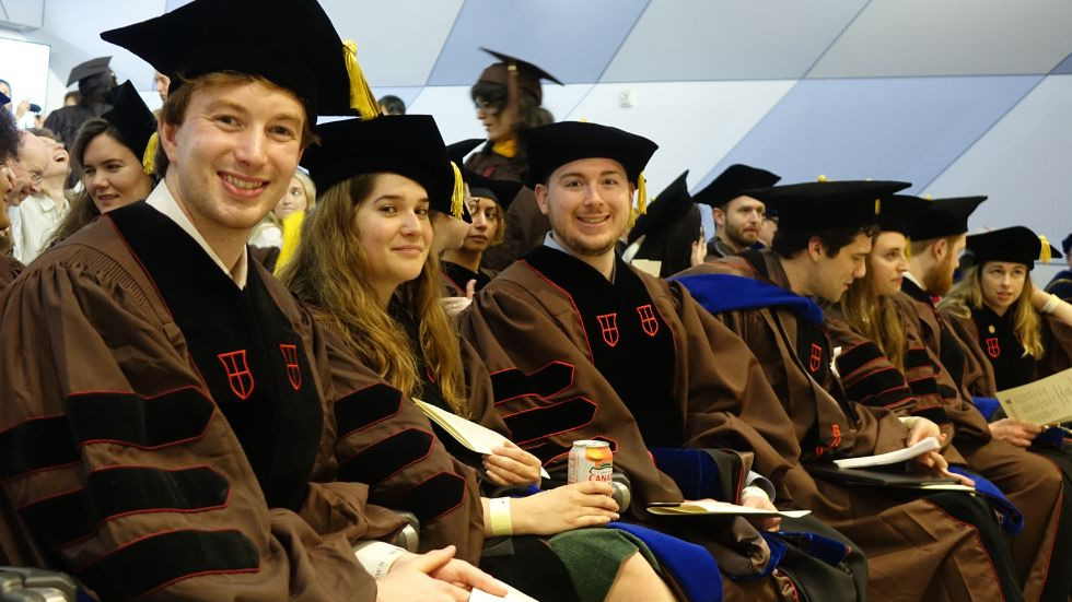 PhD graduates smiling and lauging together before the ceremony 