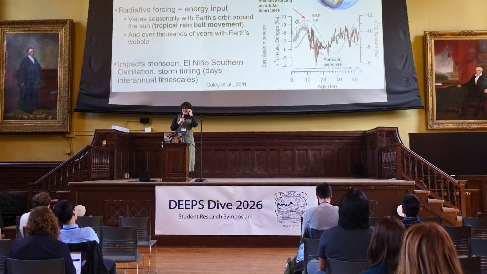 a student on stage presenting on her research