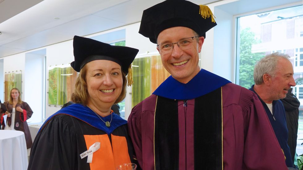 department chair and professor smile together at the reception 