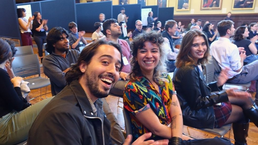 three students smile in the audience at DEEPS Dive 