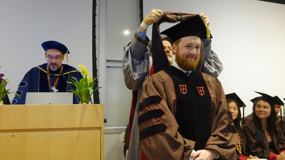 A PhD student receiving his hood 