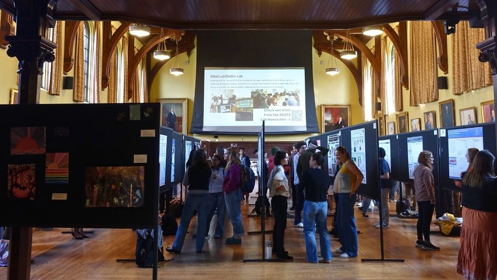 a view of Sayles Hall full of DEEPS Dive guests mingling among research posters