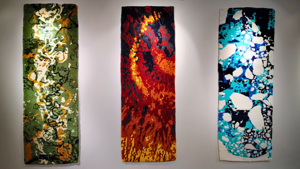 A clear wide view of the three tapestries hanging together on the wall in Lincoln Field lobby