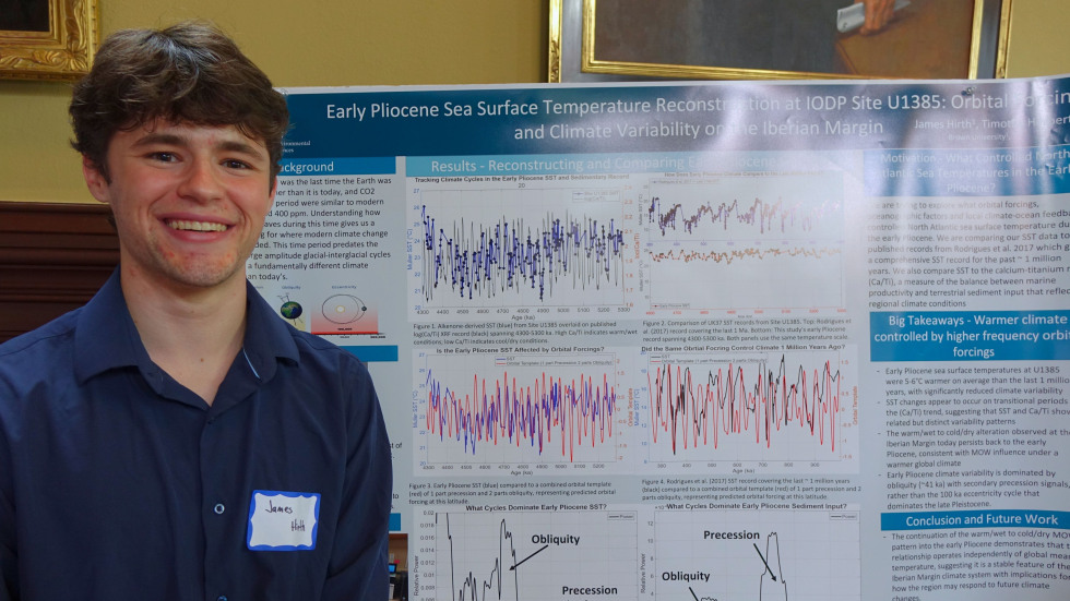 James Hirth beside his poster 
