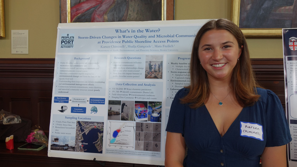 Karsen Chiminelli smiling beside her poster 
