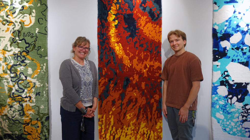 Ingrid Daubar and Ian pose beside the Mars tapestry