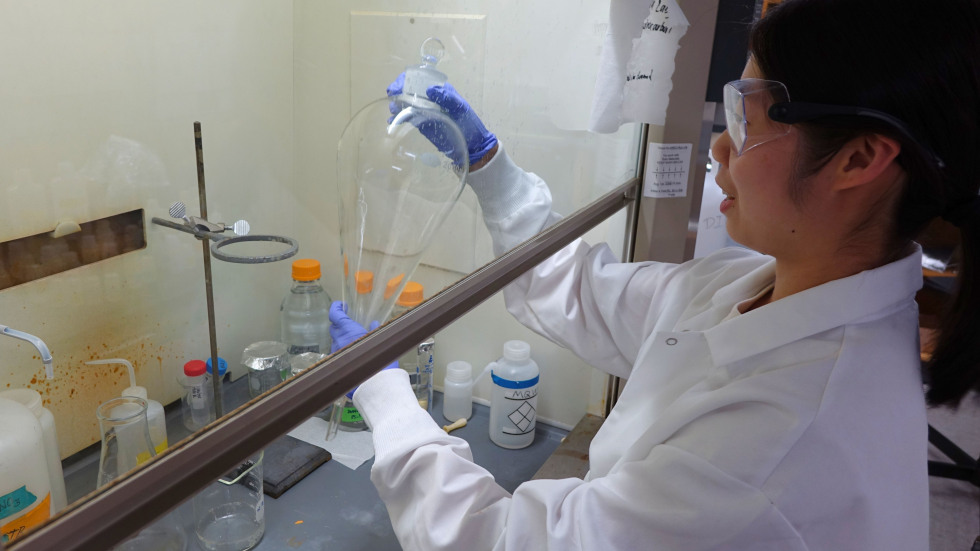 Claire Xu showing how she tests samples in the lab