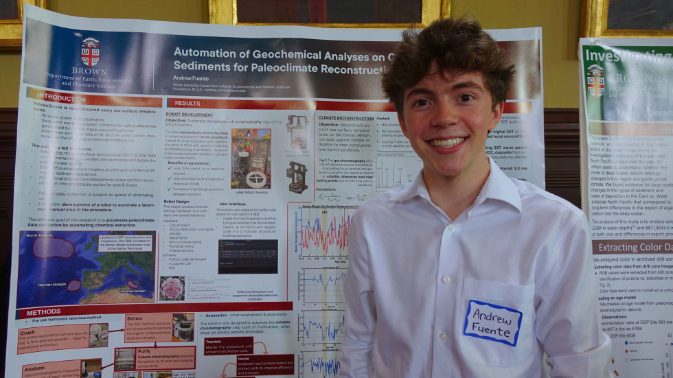 Andrew Fuente beside his poster 